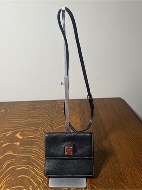 Dooney & Bourke Black Pebbled Leather Square East West Flap Crossbody Bag.